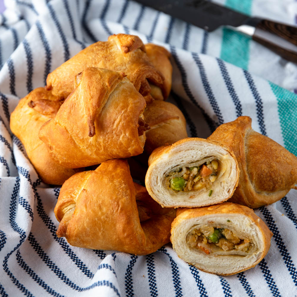 vegan cramosas with one cut open showing the inside of the stuffed croissant