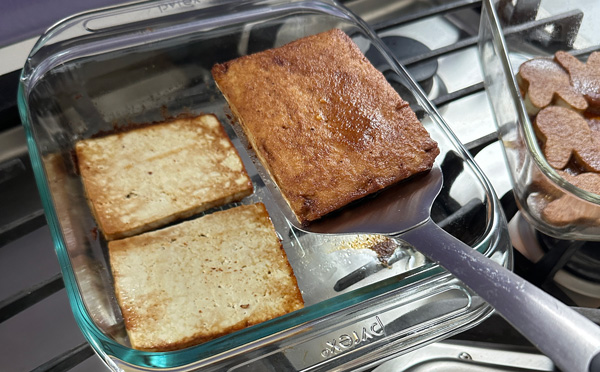flipping the vegan ham slices halfway through the baking