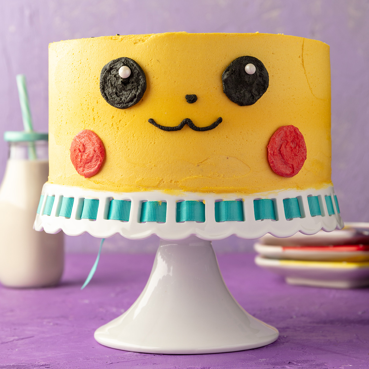 2-layer round vegan marble cake frosted and decorated to look like the pokemon pikachu