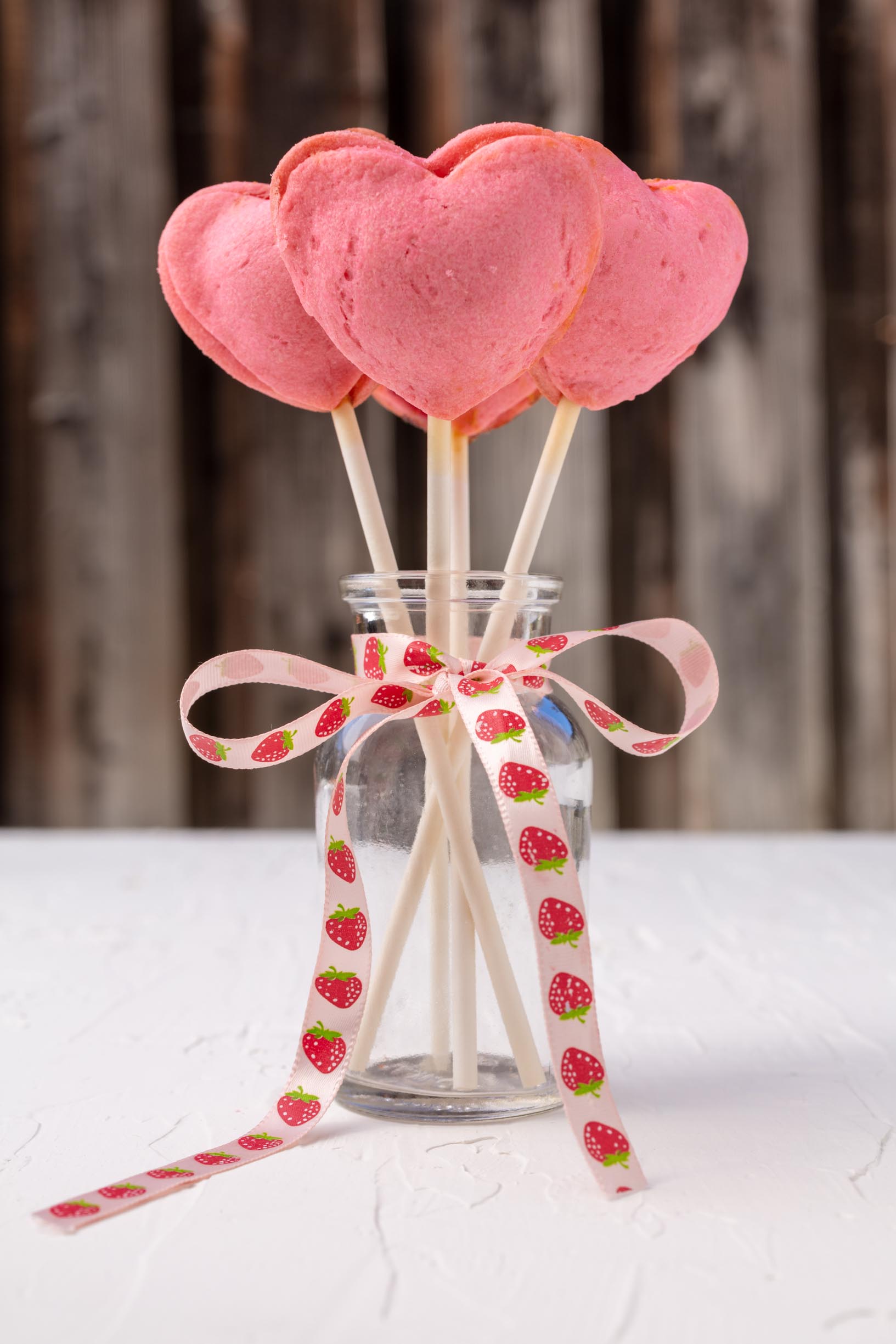 pink heart shaped pie pops sticking out of a jar tied with a bow