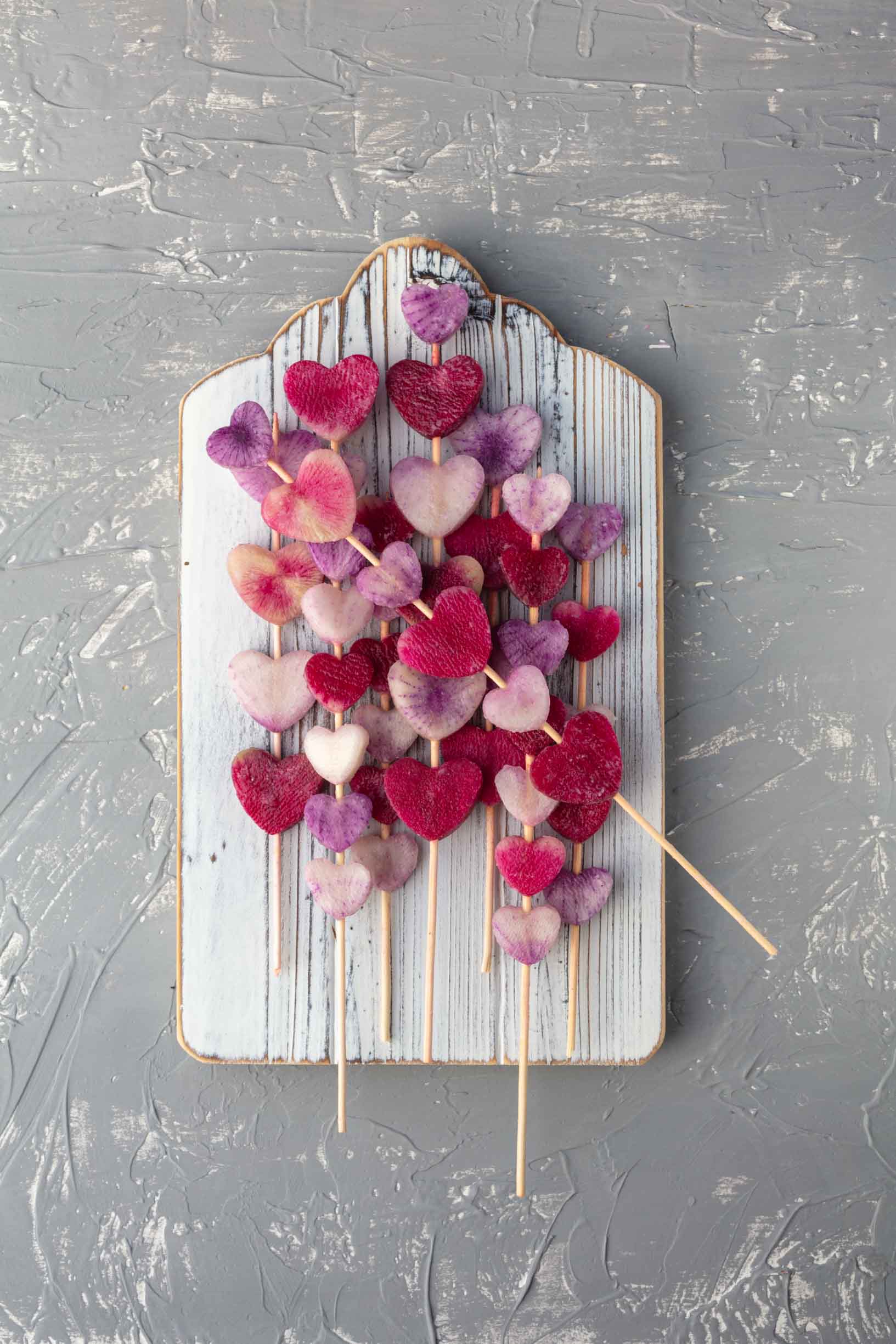threading the radish hearts onto skewers