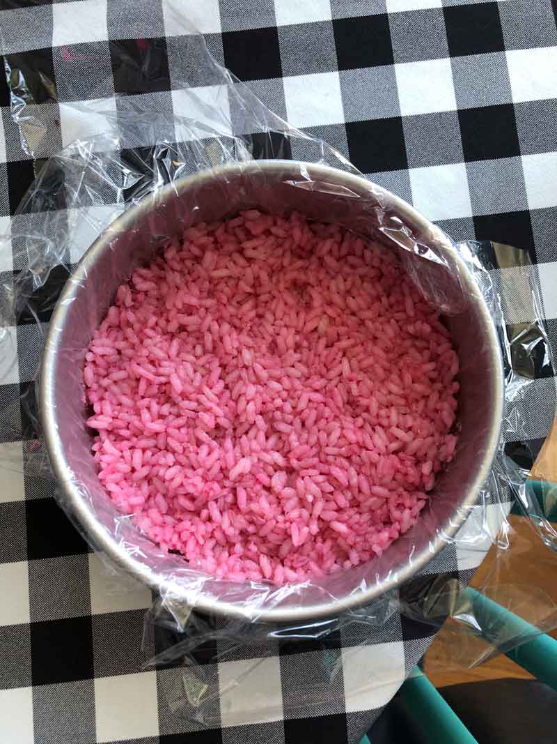 pink sushi rice in a cake pan