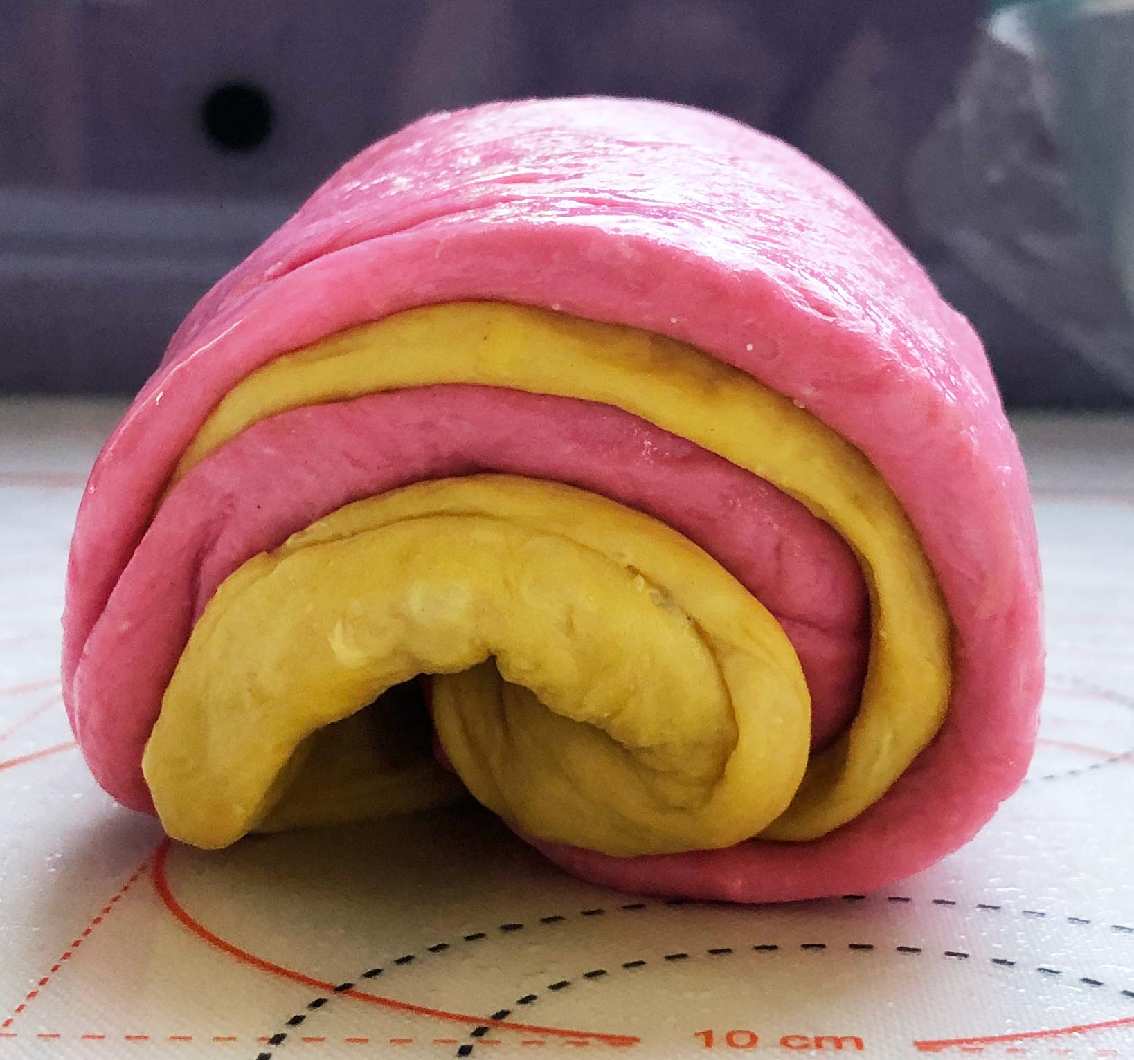 layers of dough all rolled up into a loaf shape (sort of)